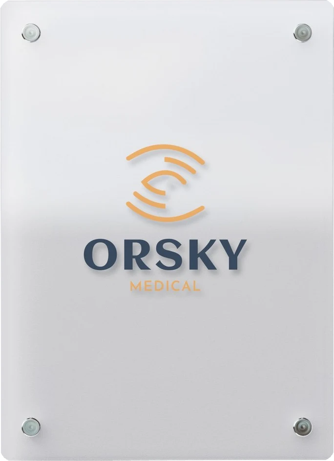 The ORSKY Medical clinic sign on frosted glass: the orange eye mark above the navy ORSKY wordmark, fixed with four chrome standoffs